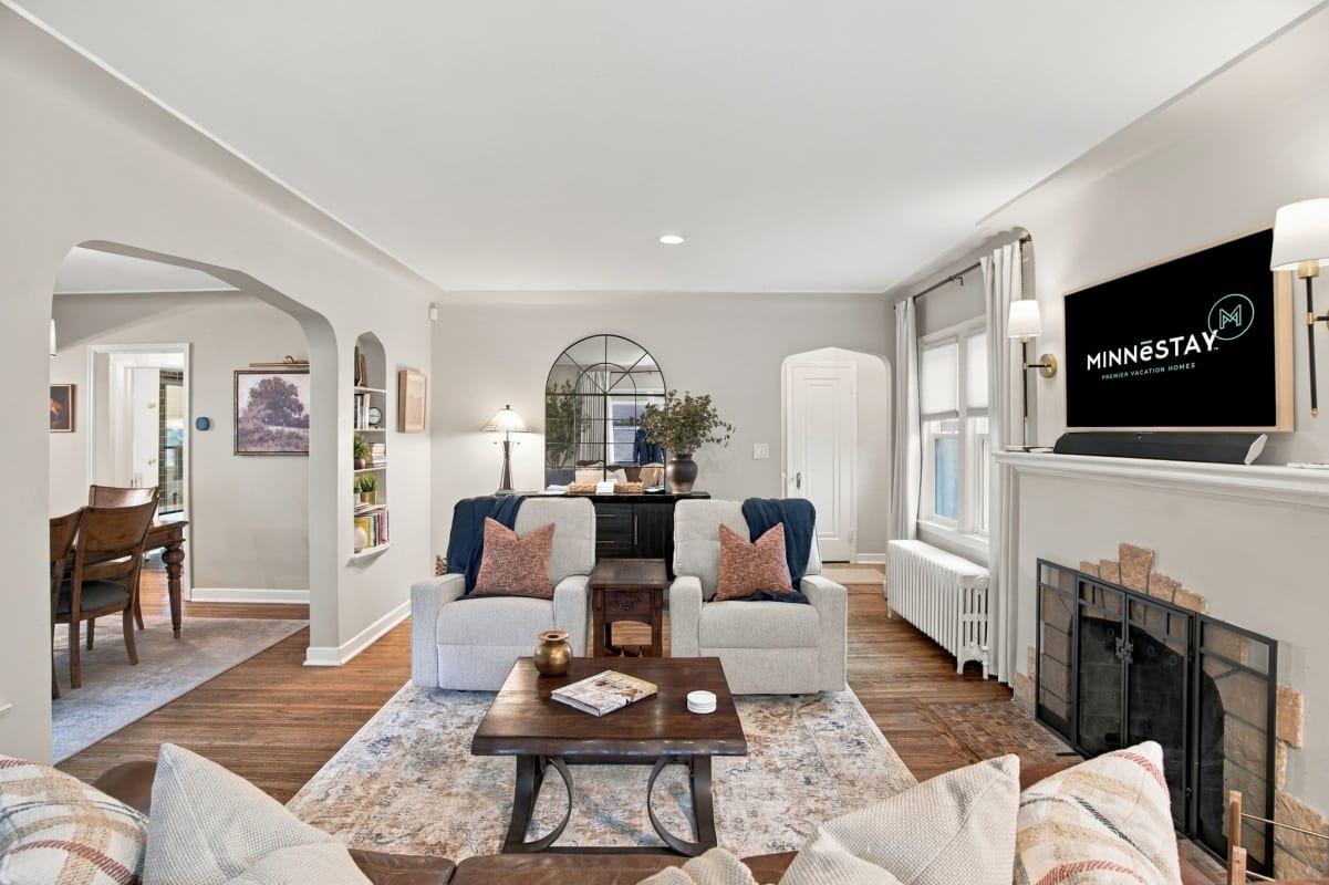 Relax in your spacious living room with plush seating and warm hardwood floors—perfect for unwinding after exploring the area.