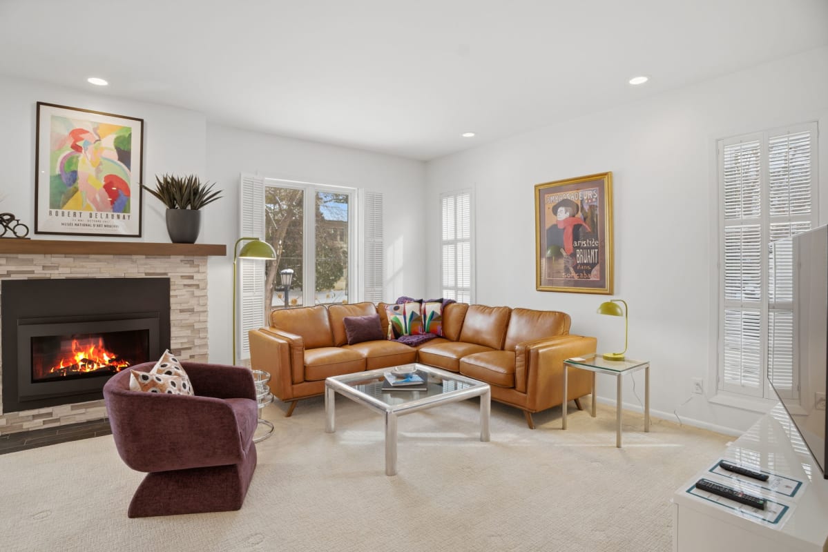 Unwind by the crackling fireplace in this stylish living room with plush leather seating and curated artwork.