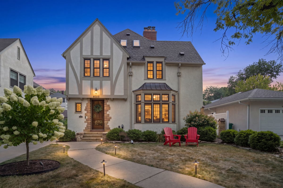 This charming Tudor-style home welcomes you with warm lighting and a beautiful exterior. The property sits in a peaceful, tree-lined neighborhood, perfect for a relaxing getaway.