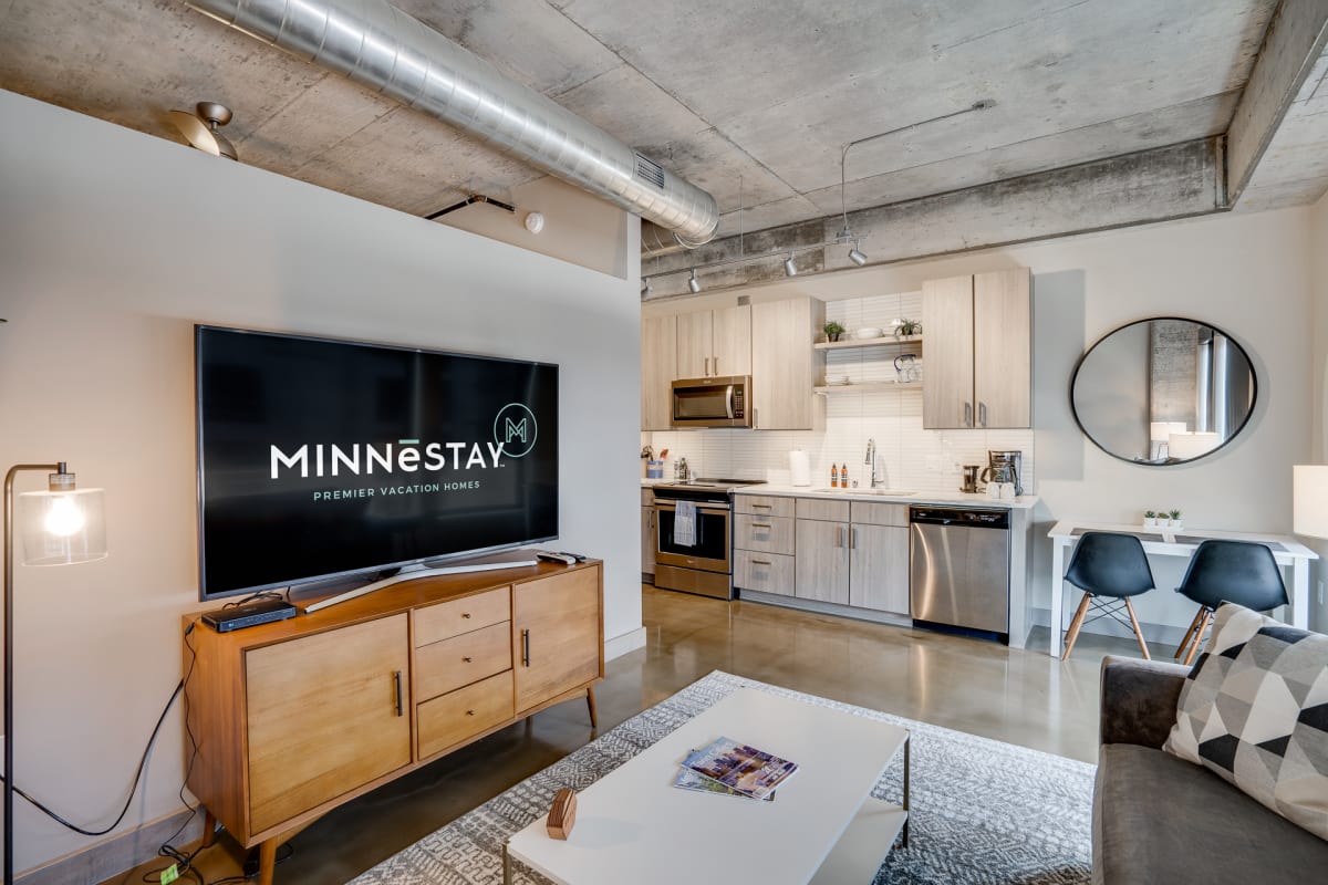 Settle into your modern urban retreat where exposed concrete meets warm wood tones, complete with a full kitchen for home cooking.