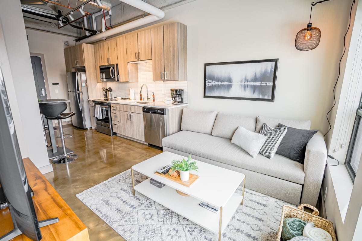Your modern loft-style retreat features an open-concept design with sleek kitchen, cozy living area, and industrial-chic details for urban comfort.