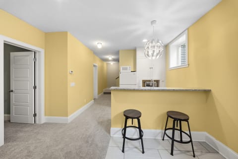 Cozy breakfast bar area with yellow walls and modern decor.