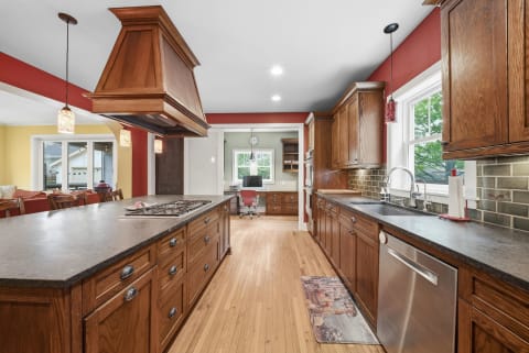 A beautifully designed kitchen featuring wood cabinetry, modern appliances, and abundant natural light.