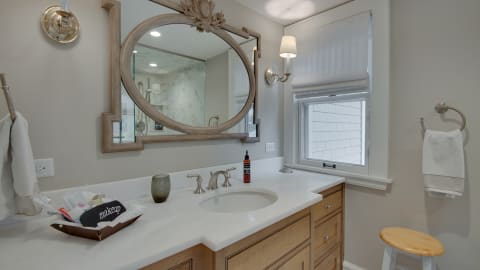 Sophisticated bathroom with a decorative vanity, ornate mirror, and warm lighting.