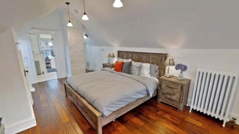 Cozy attic bedroom with wooden furnishings and soft lighting.
