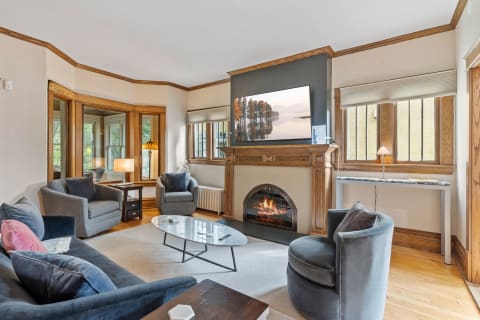 Cozy living room with a fireplace and modern furniture.