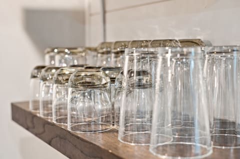 Stylish glassware displayed on a wooden shelf, ideal for various beverages.