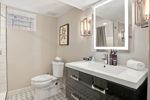 A stylish bathroom with modern finishes, including a sleek vanity and unique flooring.