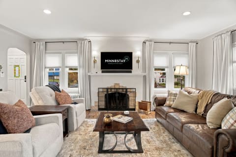 Cozy living room with gray and brown sofas, a coffee table, and large windows