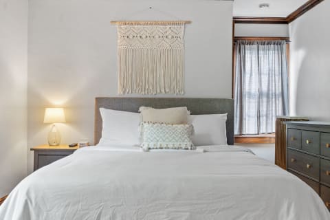 Interior view of a stylish bedroom showcasing a neatly made bed and decorative items.
