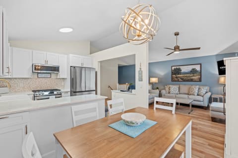 Open-plan kitchen and living area with modern decor and furniture.