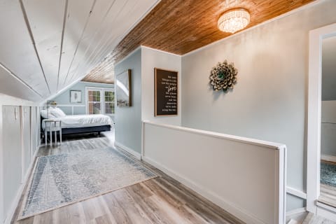Hallway leading to a bedroom with stylish decor and natural lighting.