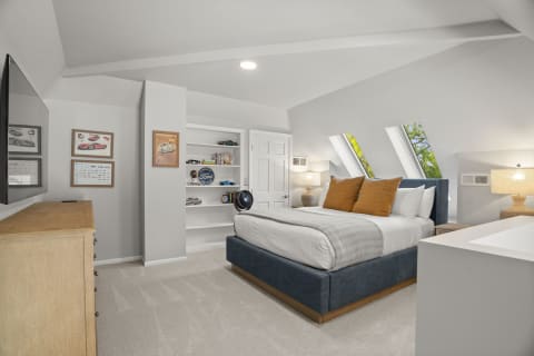 A cozy bedroom with skylights, warm pillows, and a wooden dresser, decorated with car-themed art.