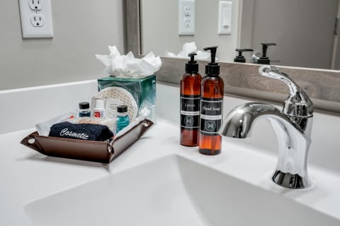 Organized bathroom countertop with lotion, hand soap, and toiletries.