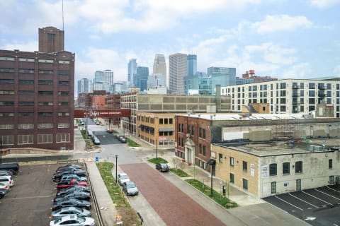 Urban cityscape showcasing historic brick buildings and modern skyscrapers.