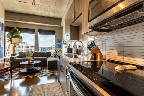 Modern kitchenette and cozy living space with urban views.