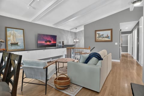 Elegant living room featuring soft seating, coastal decor, and a cozy ambiance.