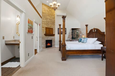 Unwind in your elegant suite where soaring ceilings, a cozy fireplace, and a majestic four-poster bed create the perfect retreat after a day of adventure.