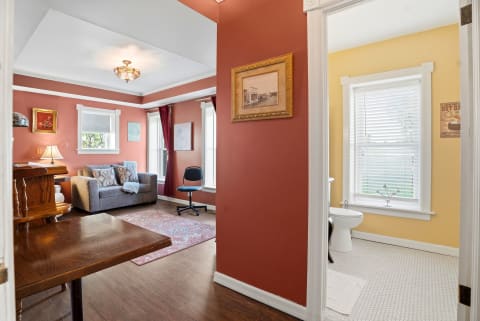 Step into a warm, inviting space where rich terracotta tones meet classic comfort. Hardwood floors, cozy seating, and thoughtful details create a relaxing retreat you'll love coming home to.
