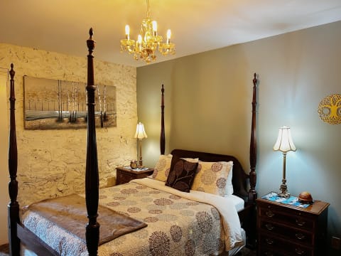 Cozy bedroom with a four-poster bed, warm colors, and elegant decor.