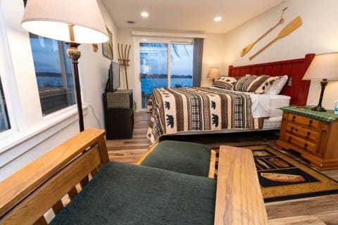 A cozy bedroom featuring a lake view, rustic decor, and a patchwork quilt.