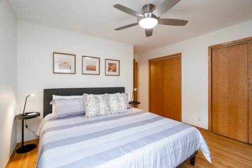 Sink into this cozy bedroom with crisp linens and gentle ceiling fan for your perfect night's rest.