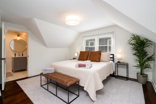 Your peaceful retreat awaits with crisp linens, warm leather accents, and an ensuite bathroom for ultimate comfort.
