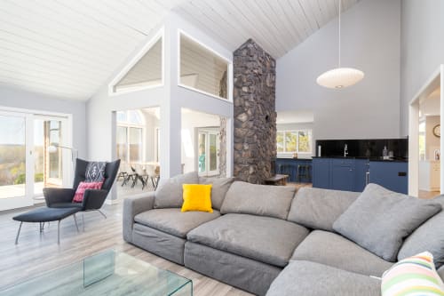 Relax in your spacious living area with soaring ceilings, cozy fireplace, and modern kitchen - perfect for unwinding after adventures.