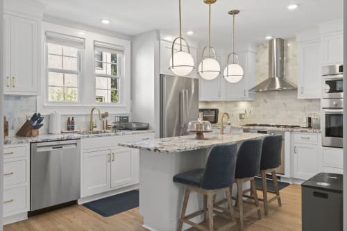 Your chef-ready kitchen awaits, with gleaming granite countertops, stainless steel appliances, and a spacious island perfect for gathering over morning coffee or prepping your favorite meals together.