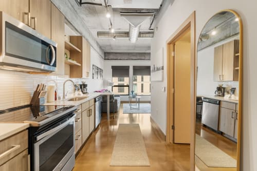 Your modern galley kitchen features sleek appliances and warm wood cabinetry, perfectly designed for creating memorable meals during your stay.