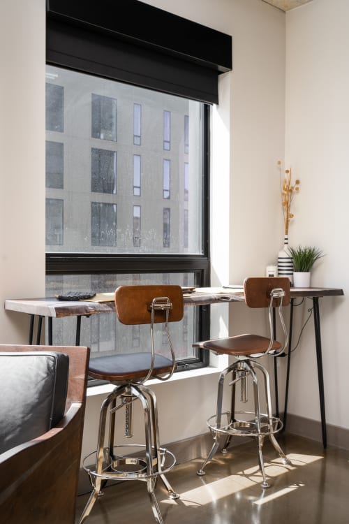 Your modern workspace with city views and stylish bar seating creates the perfect spot for morning coffee or catching up on work.