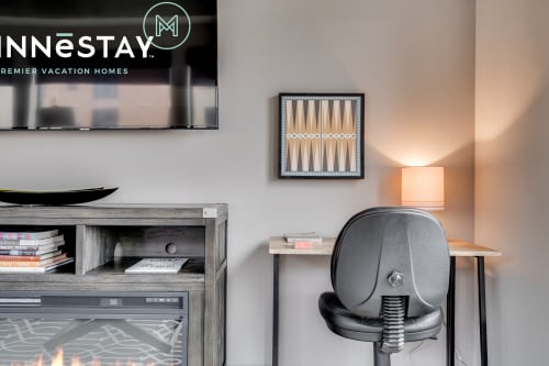 Your entertainment corner awaits with a cozy workspace, warm lighting, and classic backgammon for relaxing evenings after exploring.