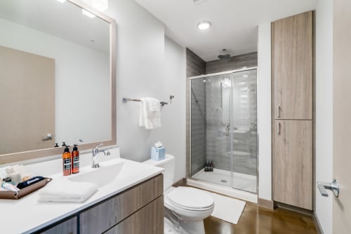 Step into your modern bathroom featuring sleek finishes, a spacious glass shower, and thoughtful storage to start each day refreshed.