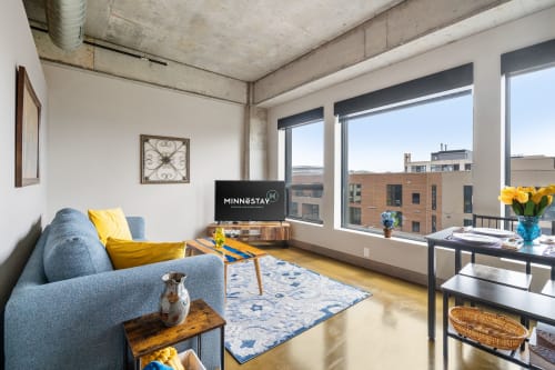 Unwind in your modern loft with city views, cozy seating, and stylish touches that make you feel right at home.