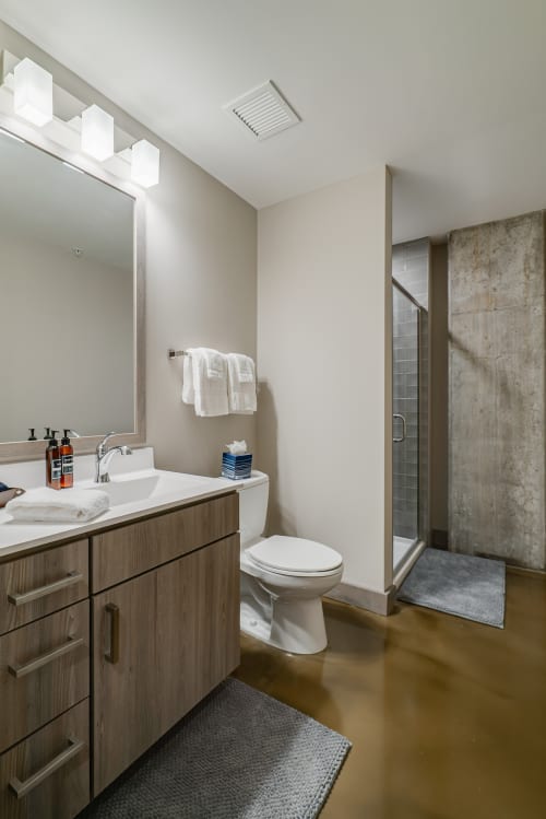 Step into your spa-like bathroom with sleek vanity, rainfall shower, and modern fixtures for ultimate relaxation.