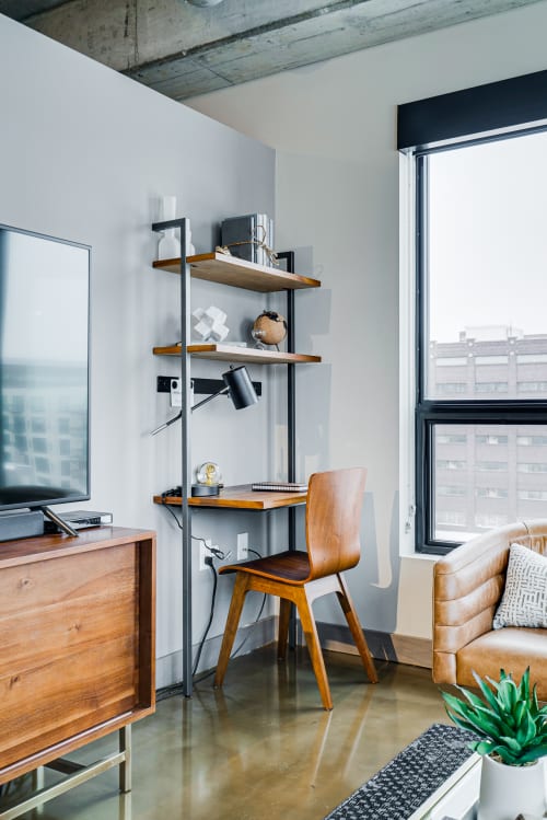 Your dedicated workspace features sleek shelving and warm wood accents, with inspiring city views to fuel your productivity.