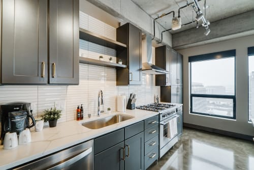 Cook your favorite meals in this sleek modern kitchen with premium appliances, stylish backsplash, and city views from the large window.