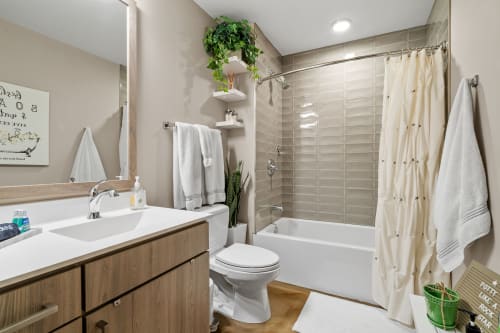 Refresh in your modern bathroom with a soaking tub, rainfall shower, and fresh towels waiting for your relaxing retreat.