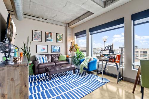 Unwind in your stylish loft where exposed concrete meets vibrant artwork, and floor-to-ceiling windows frame stunning city views.