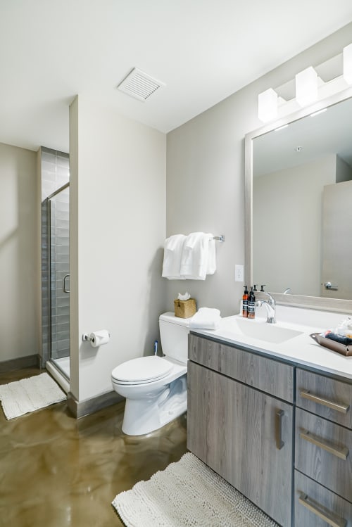 Step into your sleek, modern bathroom featuring premium finishes and thoughtful amenities for your comfort.