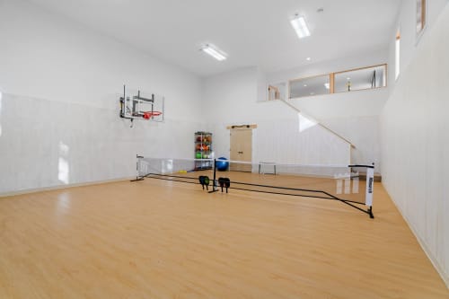 Your private indoor court awaits with basketball hoop and exercise equipment for endless active fun.