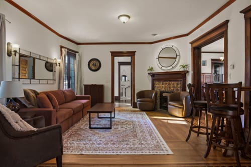 Settle into your elegant living space where rich wood details and a cozy fireplace create the perfect atmosphere for relaxing evenings together.