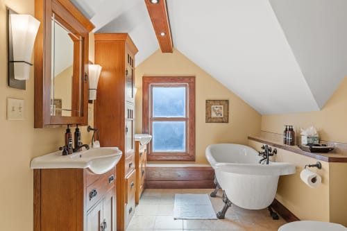Soak away your cares in this elegant clawfoot tub while admiring the crafted woodwork and peaceful ambiance of your private retreat.