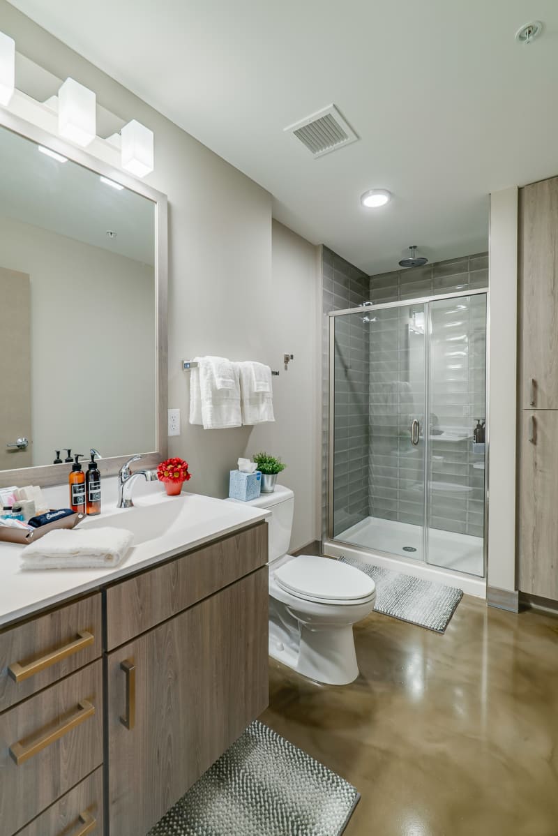 Unwind in your spa-like bathroom featuring a spacious glass shower, modern vanity, and elegant finishes that create your perfect morning routine.
