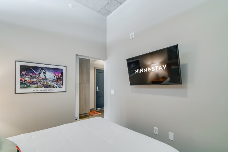 Unwind in your stylish bedroom with modern art and a smart TV for your entertainment.