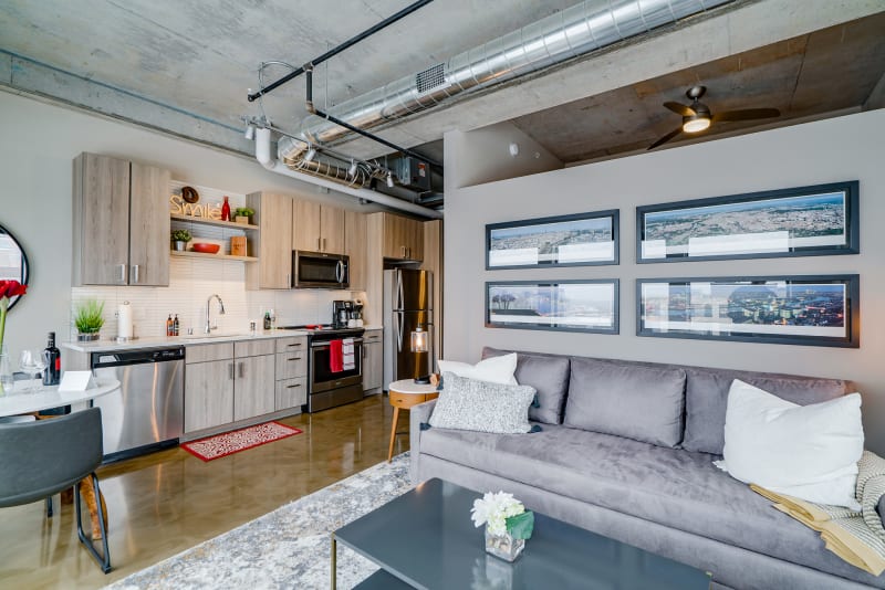 Unwind in this stylish loft where exposed ceilings meet modern comfort-your fully equipped kitchen and cozy seating await.