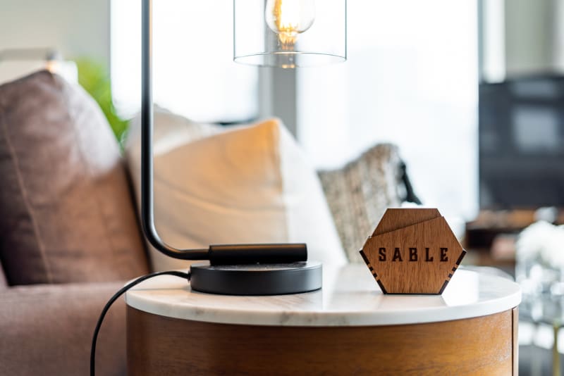 Settle into your cozy living space with warm wood accents and stylish lighting that creates the perfect ambiance for relaxation.
