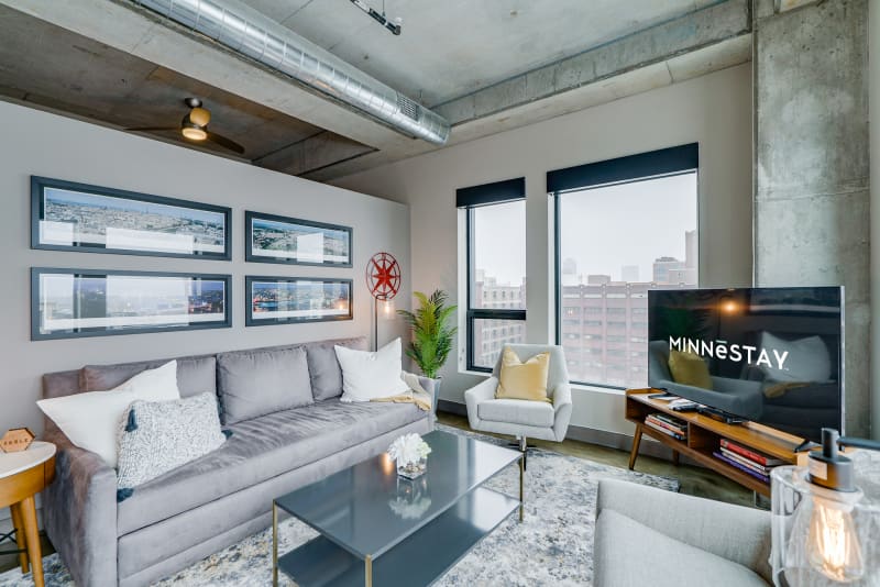 Relax in your stylish loft with exposed concrete, city views, and modern furnishings that create an urban sanctuary.