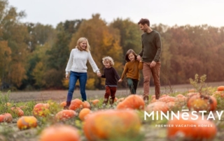 Family walking through a fall festival pumpkin patch