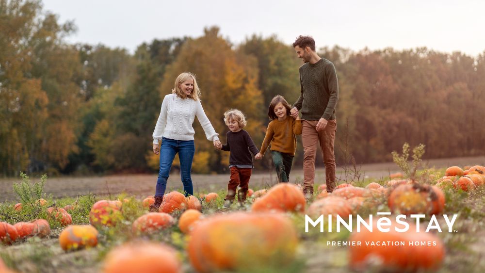 Family walking through a fall festival pumpkin patch